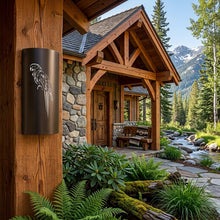 Load image into Gallery viewer, Macaw parrot wall sconce in oil-rubbed bronze, mounted on a timber post at the entrance to a mountain lodge