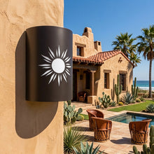 Load image into Gallery viewer, Southwest sun wall sconce in oil-rubbed bronze, mounted on an adobe wall beside a tiled-roof courtyard